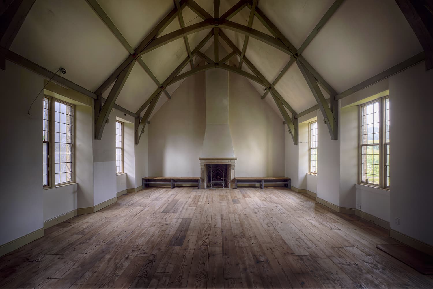 Great room with a high vaulted ceiling, painted rafters and a plaster chimney breast to the ridge