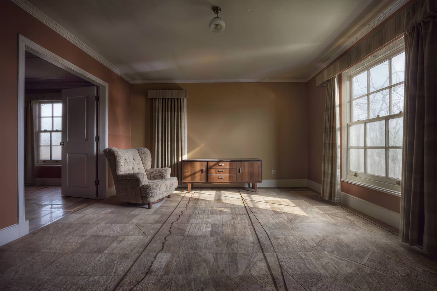 Bright open living room with vacuum tracks across a flat weave rug in morning light