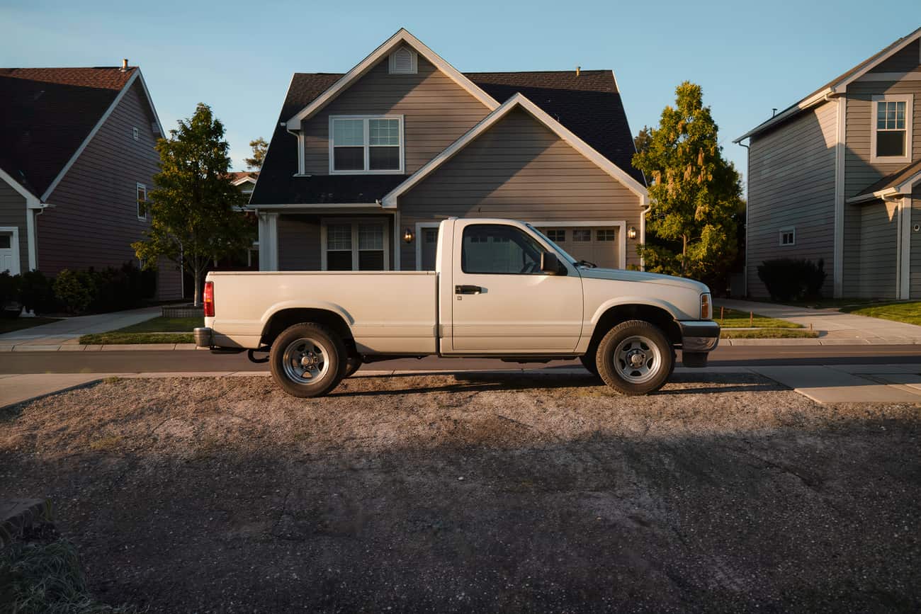 A freshly detailed full-size pickup parked square on a wide suburban drive