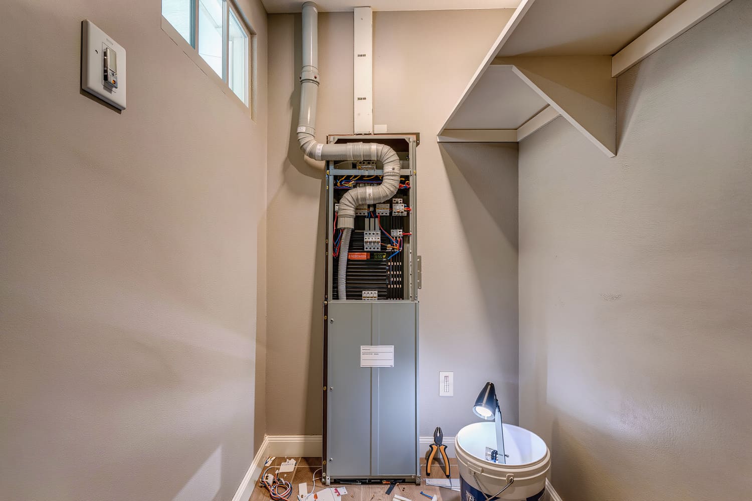 Residential load centre with the dead front off and conductors part-dressed mid-upgrade