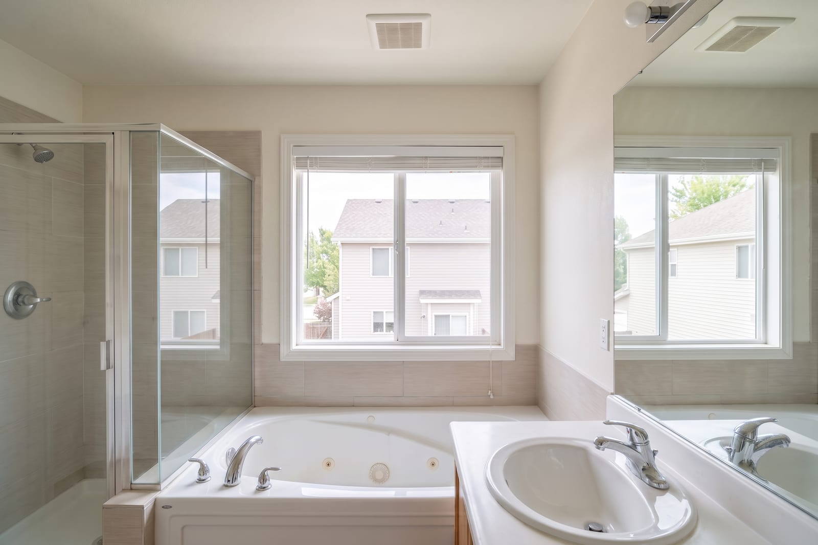 Bright, freshly cleaned bathroom with sparkling tiles and a polished mirror