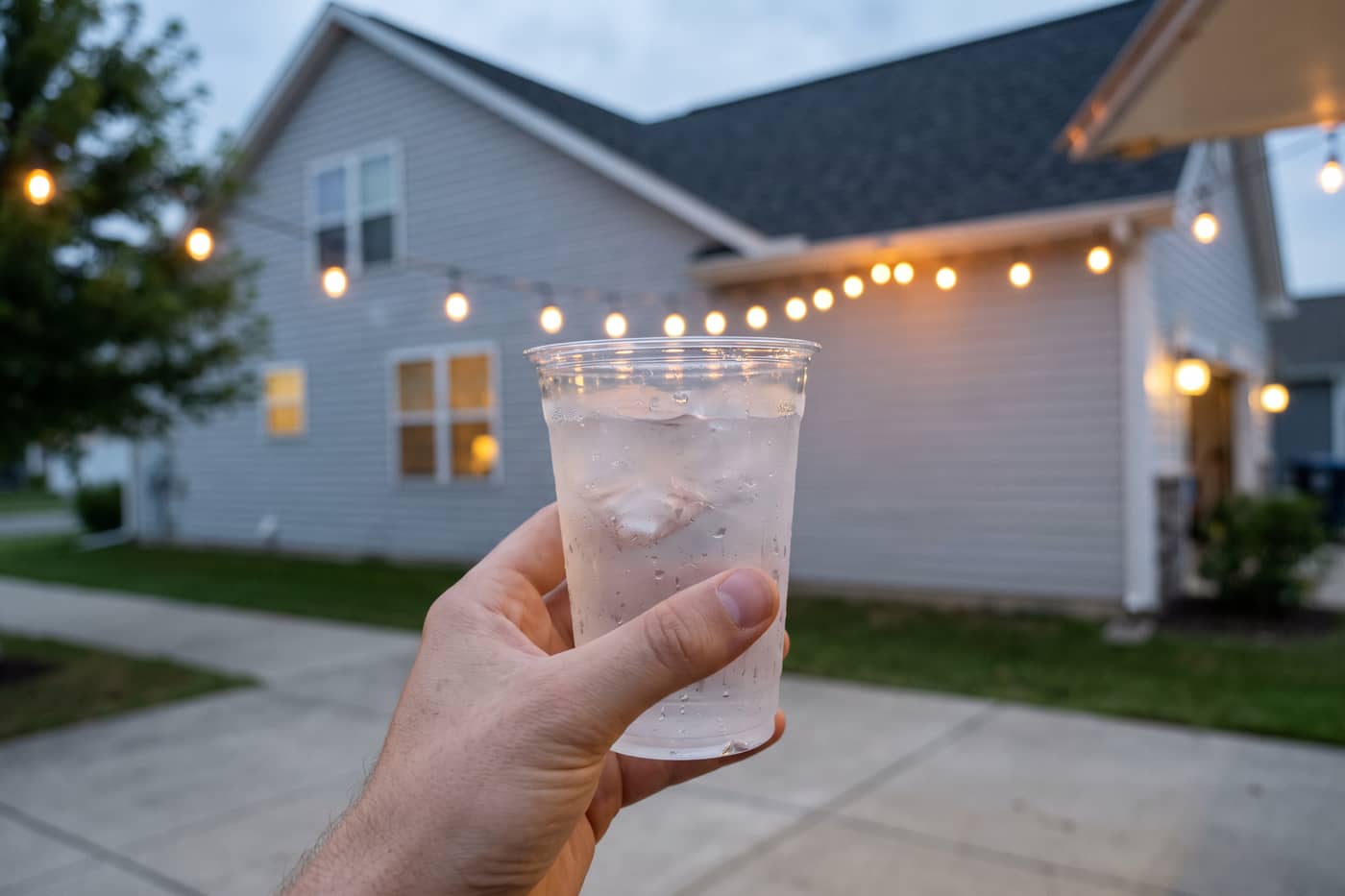 Cold drink in a plain unprinted cup, beaded with condensation
