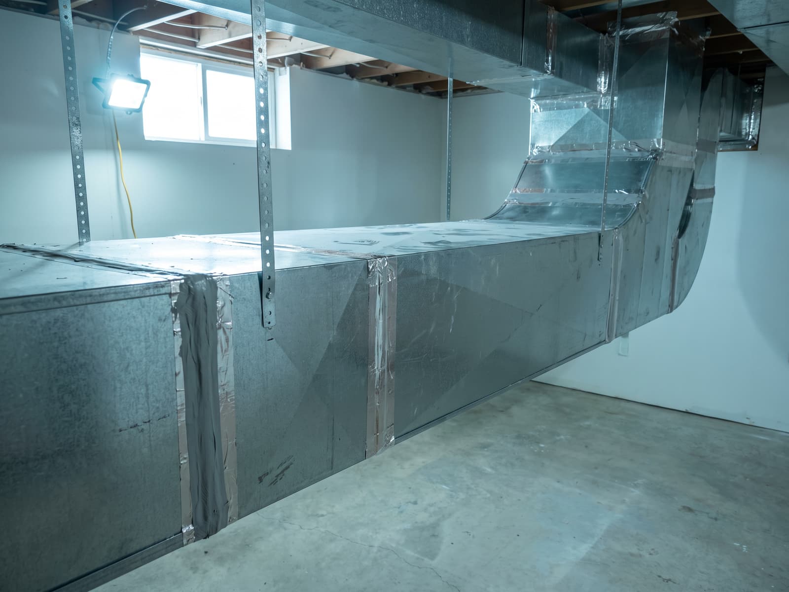 New rigid trunk ductwork with mastic-sealed joints and evenly spaced hangers